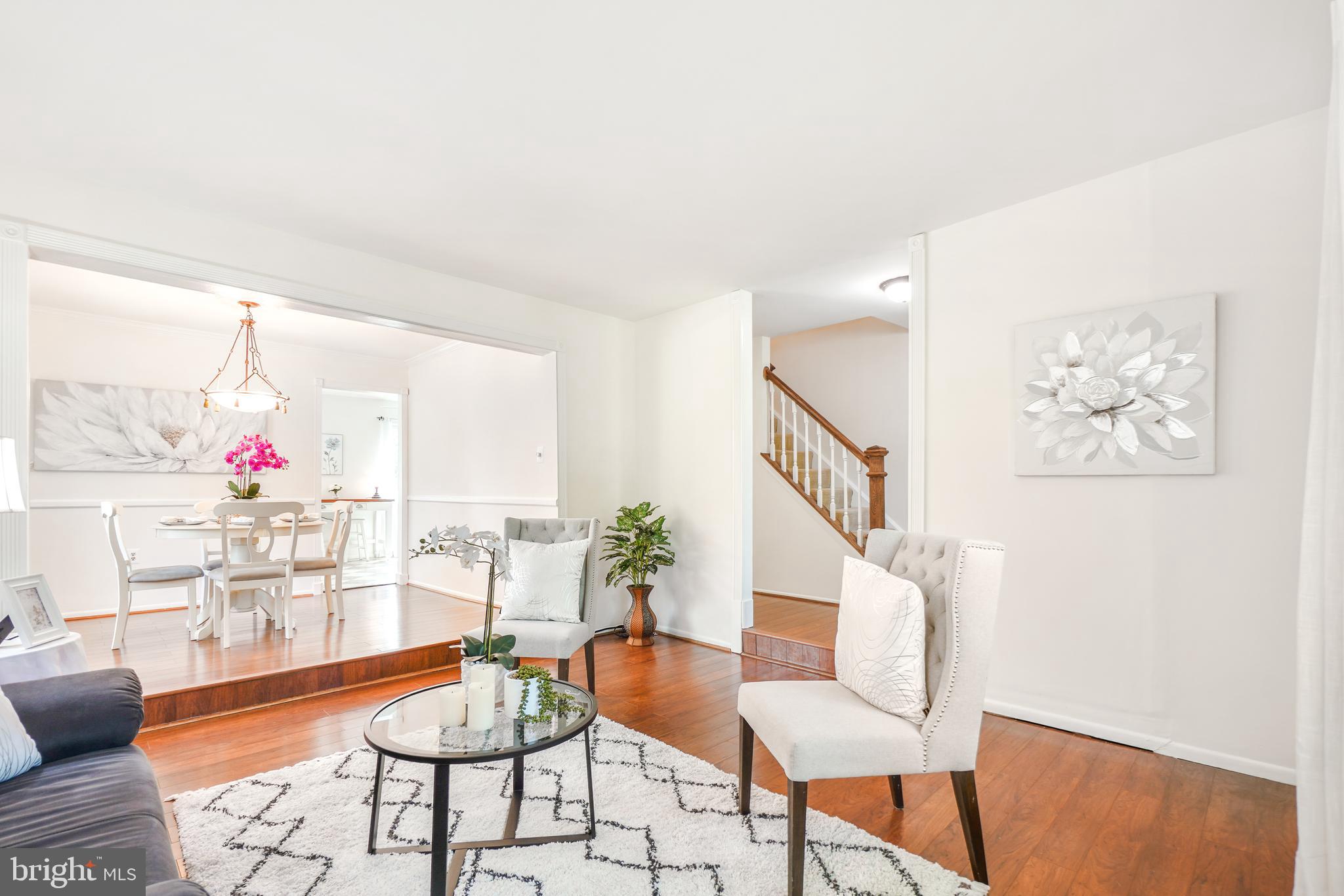 8900 Centerway Road Gaithersburg, MD 20879 - Photo 3 of 32 a living room with furniture and a table