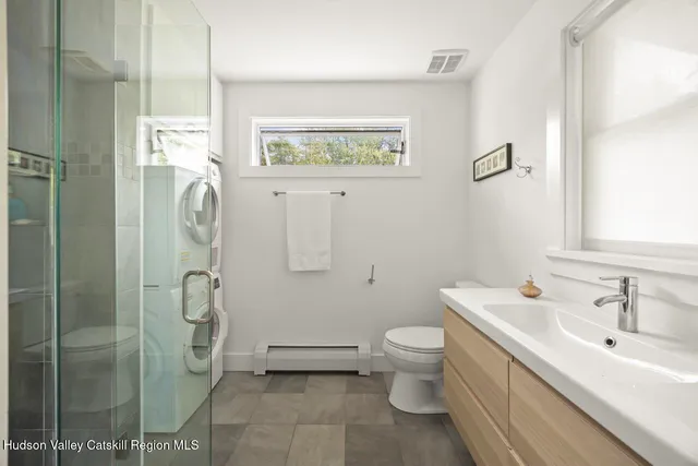 a bathroom with a toilet sink and shower