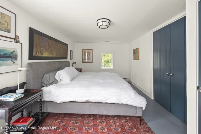 a bedroom with a bed and dresser