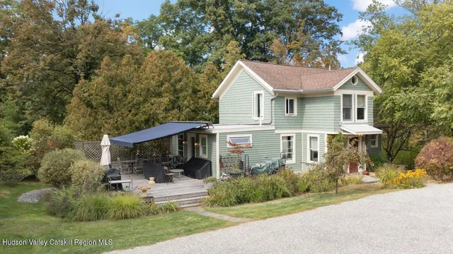 a front view of a house with a yard and porch