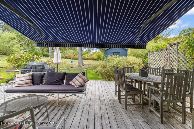 a view of a patio with table and chairs and wooden floor