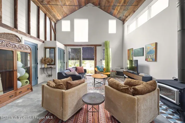 a living room with furniture and a floor to ceiling window