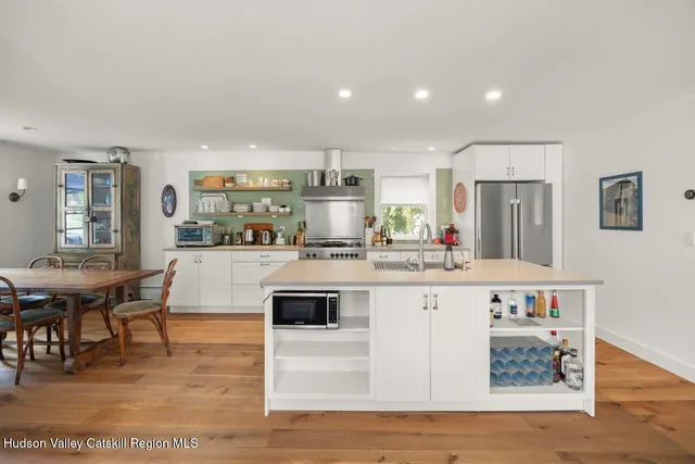 a kitchen with stainless steel appliances granite countertop a sink and a refrigerator
