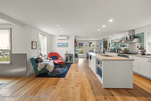 a living room with furniture and kitchen view