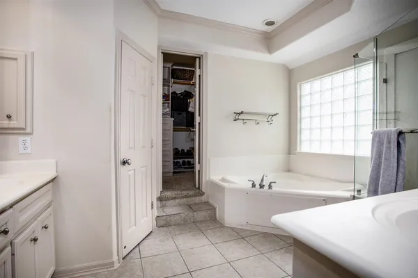 a spacious bathroom with a bathtub and a sink