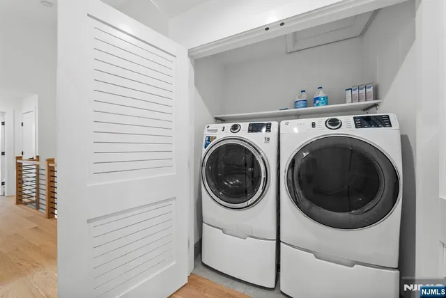 a view of a hallway with wooden floor and stairs