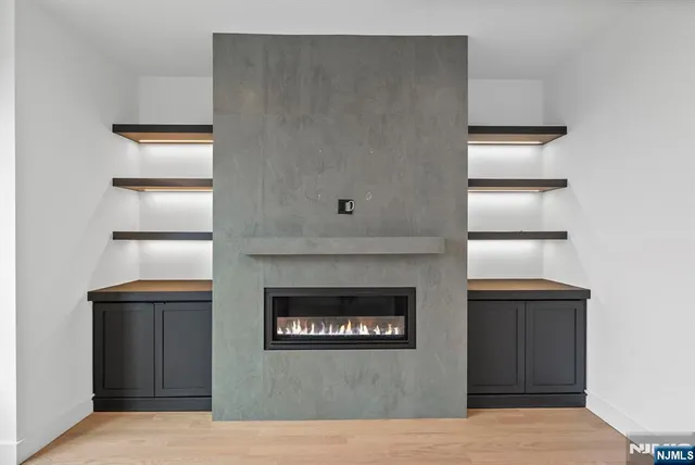 a view of an empty room with a fireplace and a window