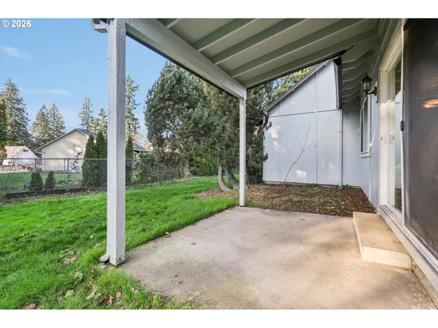 a view of a backyard with barn and garden