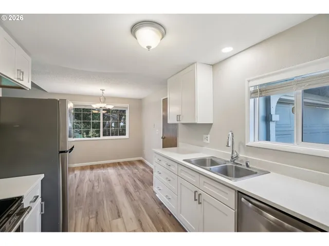 a kitchen with a sink cabinets and window
