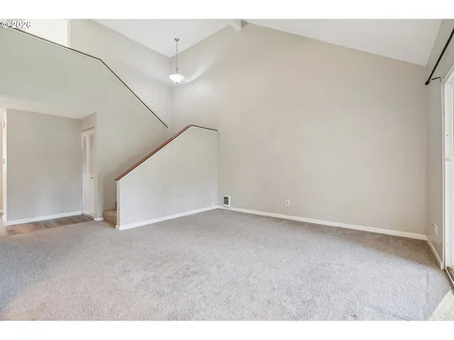 a view of an empty room with a ceiling fan