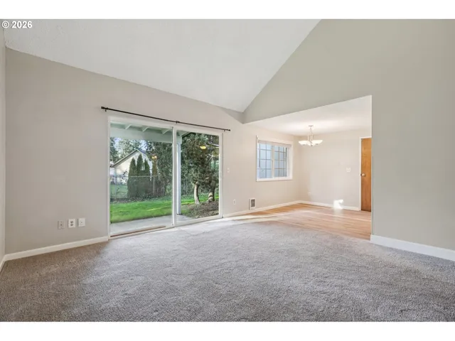 a view of empty room with floor to ceiling window