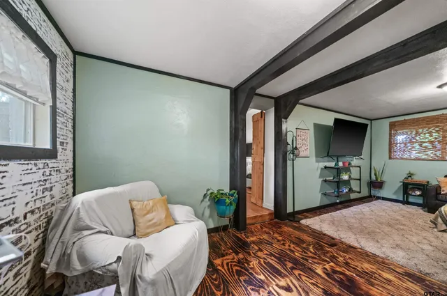 a bedroom with a bed and a large window