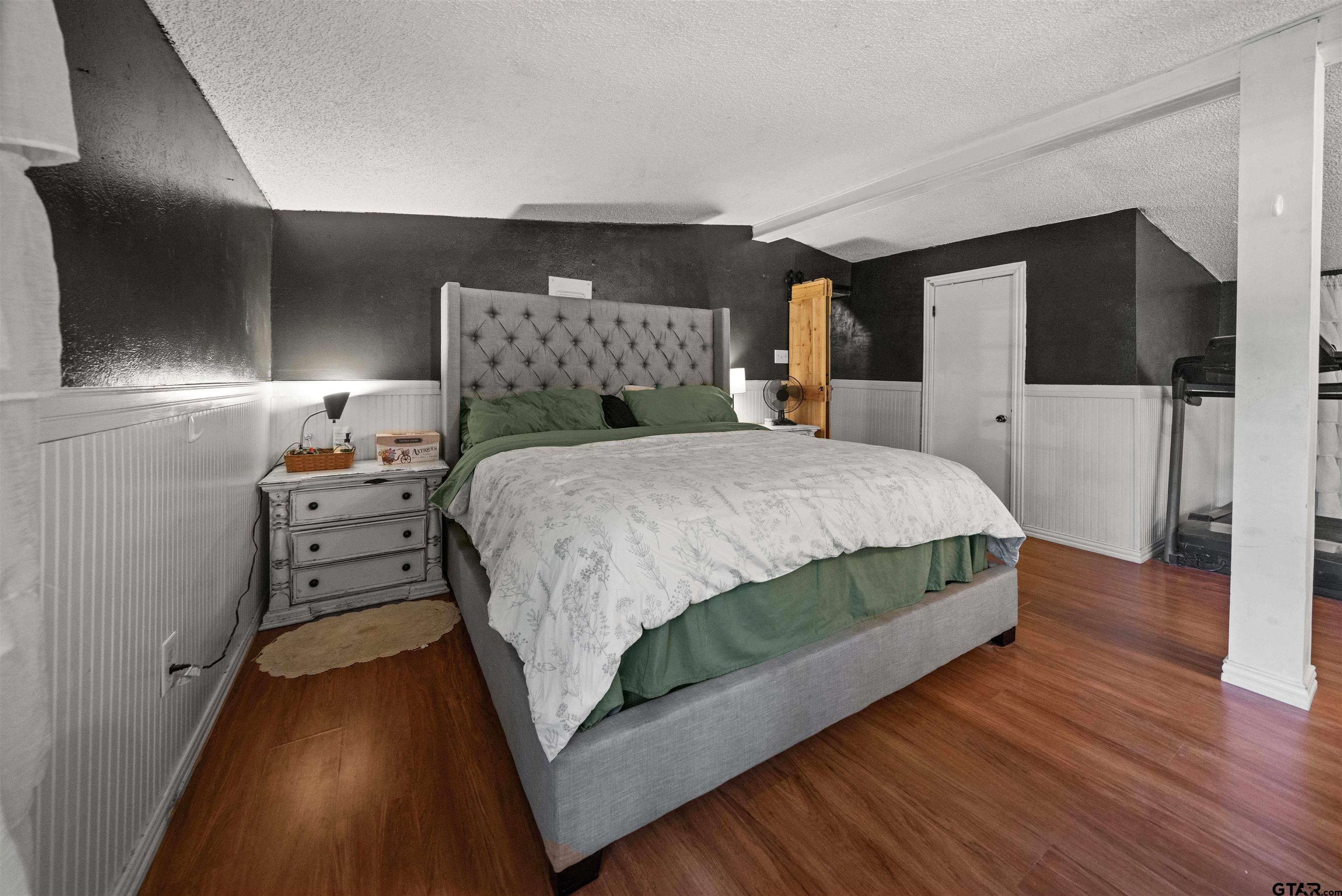 110 Utah Street Van, TX 75790 - Photo 20 of 48 a bedroom with a bed and a wooden floor