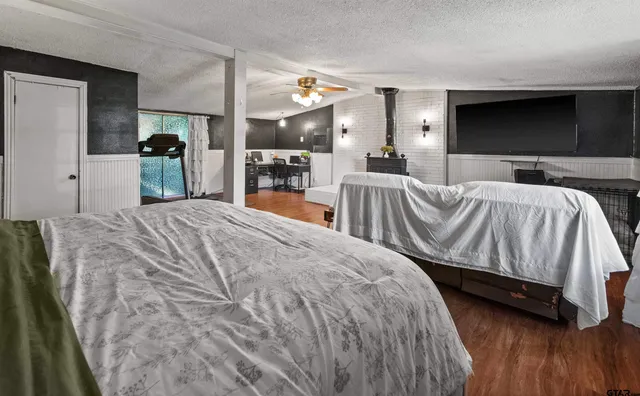 a bedroom with a bed and a flat screen tv