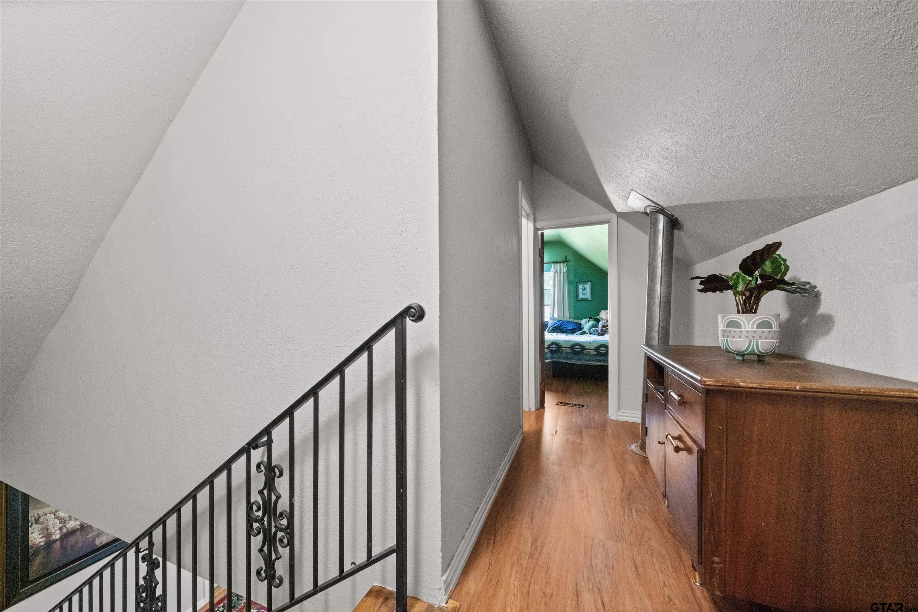 110 Utah Street Van, TX 75790 - Photo 22 of 48 a view of hallway with wooden floor and stairs