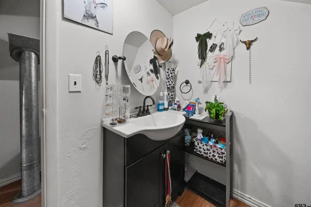 a bathroom with a sink vanity and a mirror