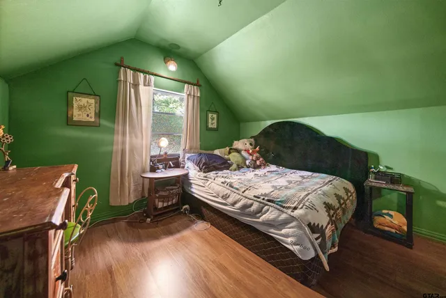 a bedroom with a bed table and a window