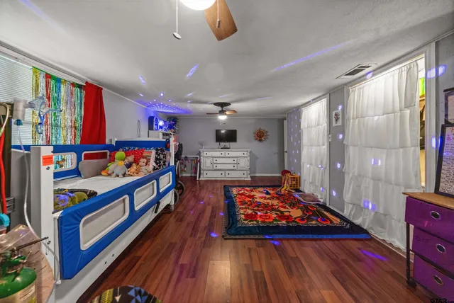 a view of a hallway with furniture and wooden floor