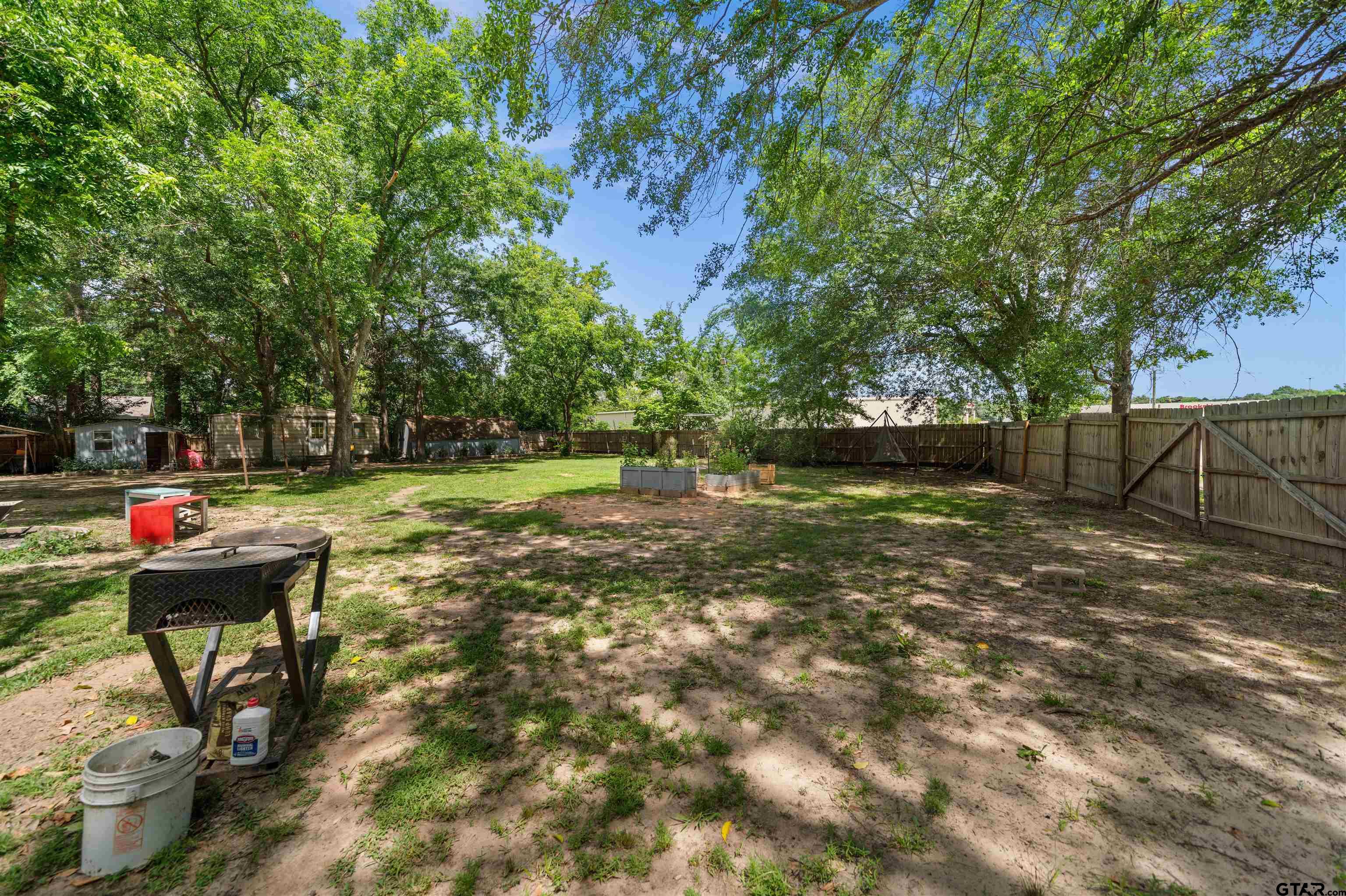 110 Utah Street Van, TX 75790 - Photo 41 of 48 a backyard of a house with barbeque oven table and chairs