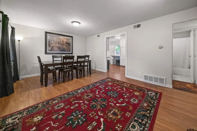 a living room with furniture rug and wooden floor