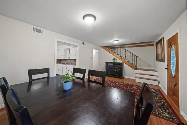 a dining room with furniture and wooden floor