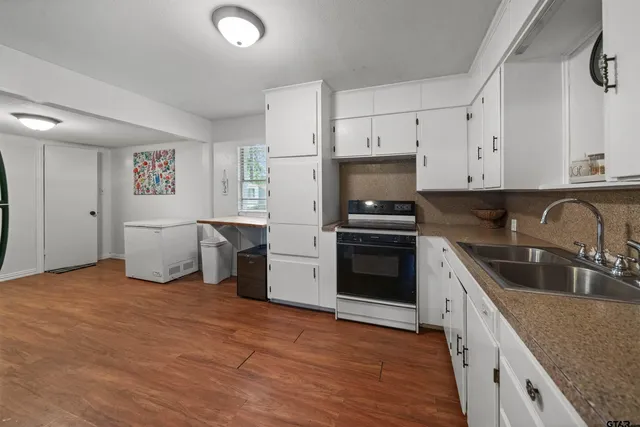 a kitchen with stainless steel appliances granite countertop a refrigerator sink and stove