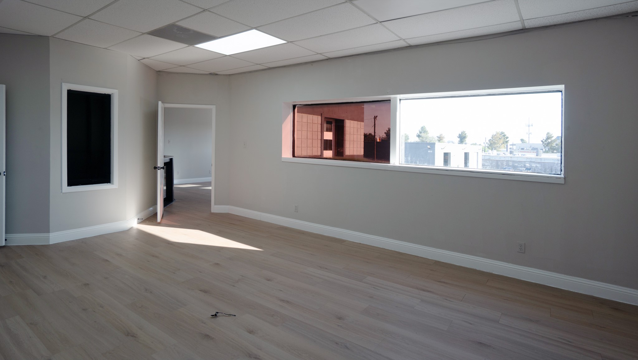9220 Rasmus Drive Houston, TX 77063 - Photo 16 of 30 an empty room with wooden floor and windows