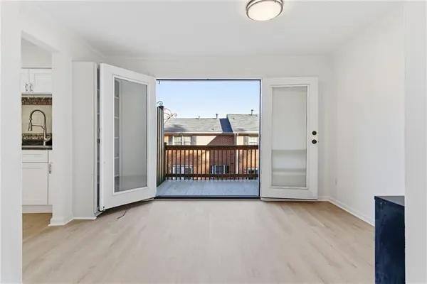 a view of a room with wooden floor and windows