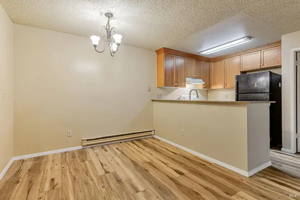 a kitchen with kitchen island a counter top space appliances and cabinets