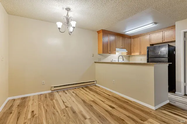 a kitchen with kitchen island a counter top space appliances and cabinets