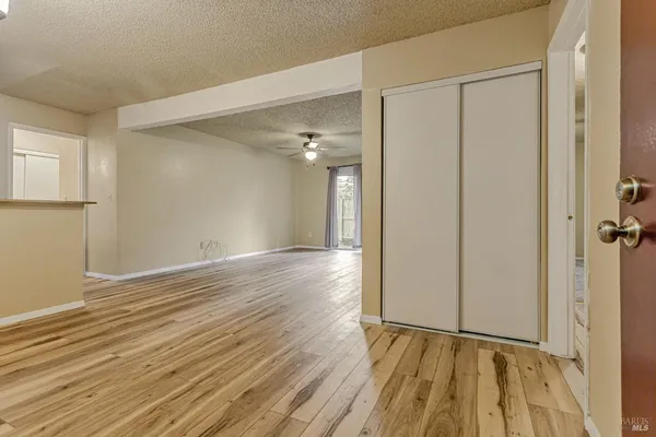 a view of an empty room with wooden floor