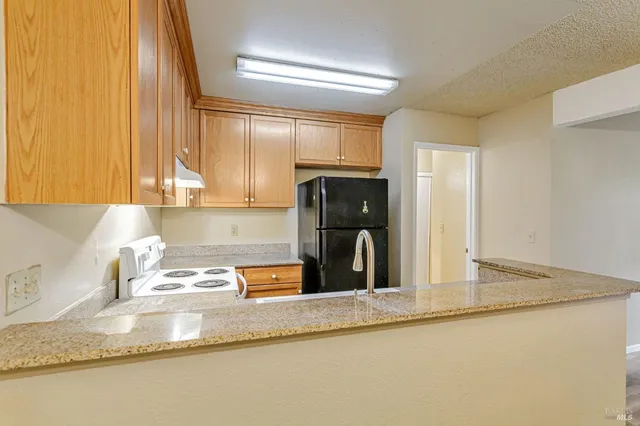 a kitchen with a refrigerator and a sink