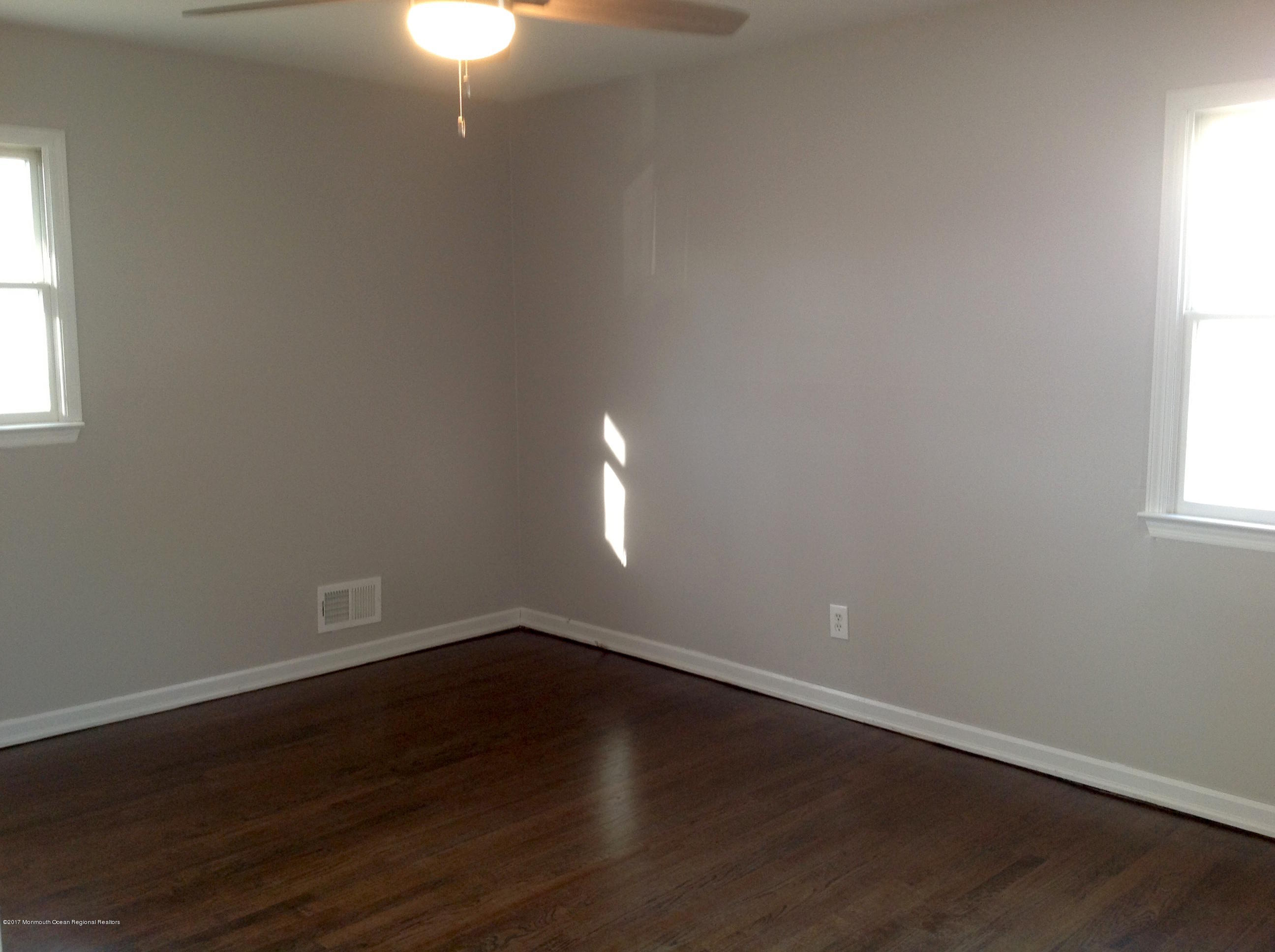 10 Carriage Road North Hazlet, NJ 07730 - Photo 14 of 24 a view of an empty room with wooden floor and a window
