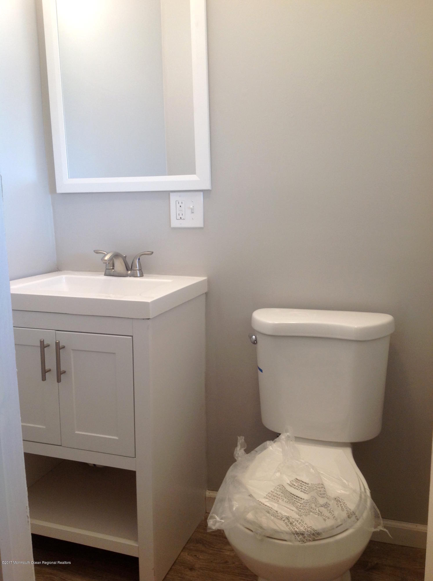 10 Carriage Road North Hazlet, NJ 07730 - Photo 19 of 24 a white toilet sitting next to a bathroom sink