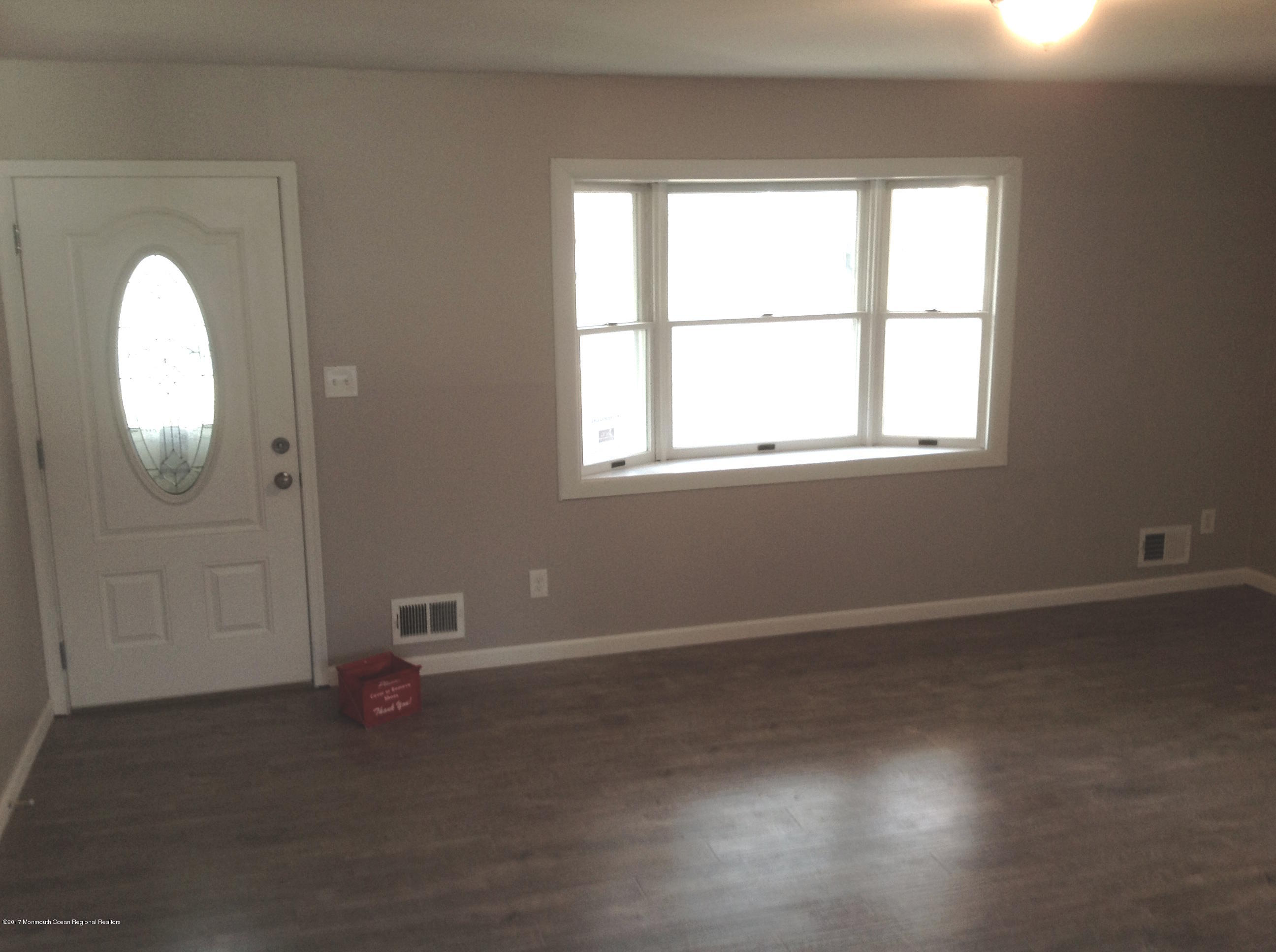 10 Carriage Road North Hazlet, NJ 07730 - Photo 2 of 24 an empty room with wooden floor and windows