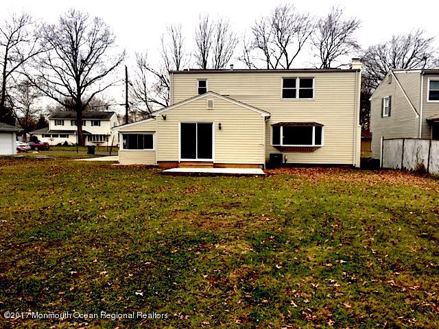 10 Carriage Road North Hazlet, NJ 07730 - Photo 23 of 24 a white house that has a big tree in front of it