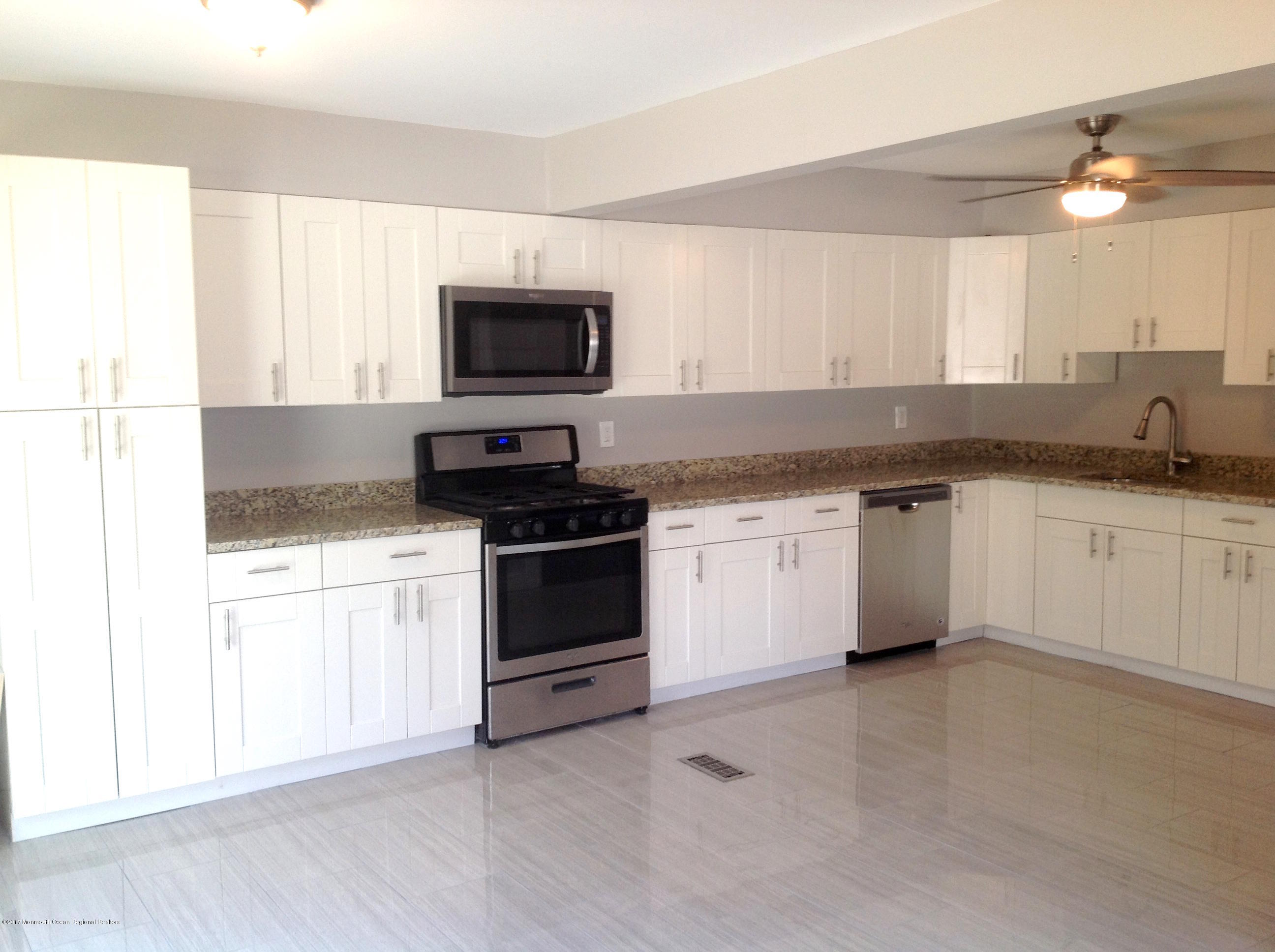 10 Carriage Road North Hazlet, NJ 07730 - Photo 6 of 24 a kitchen with granite countertop white cabinets and stainless steel appliances