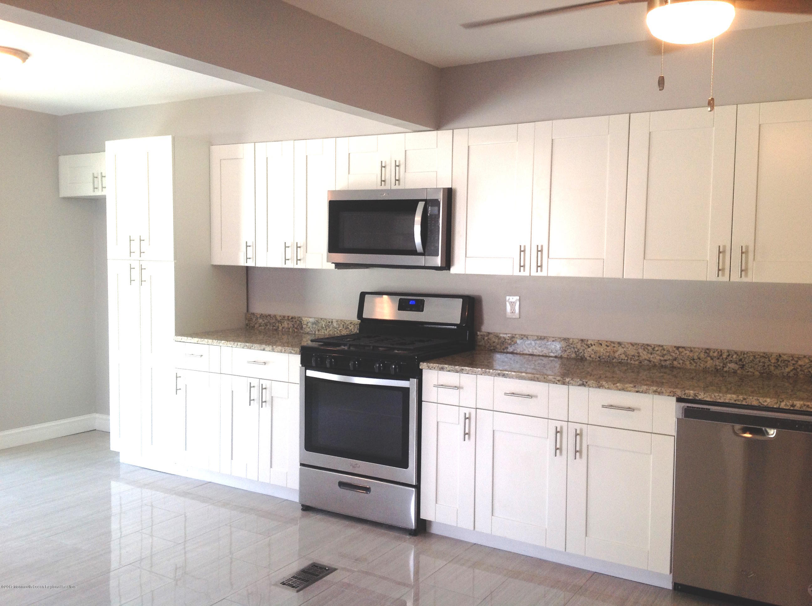 10 Carriage Road North Hazlet, NJ 07730 - Photo 7 of 24 a kitchen with granite countertop white cabinets and appliances