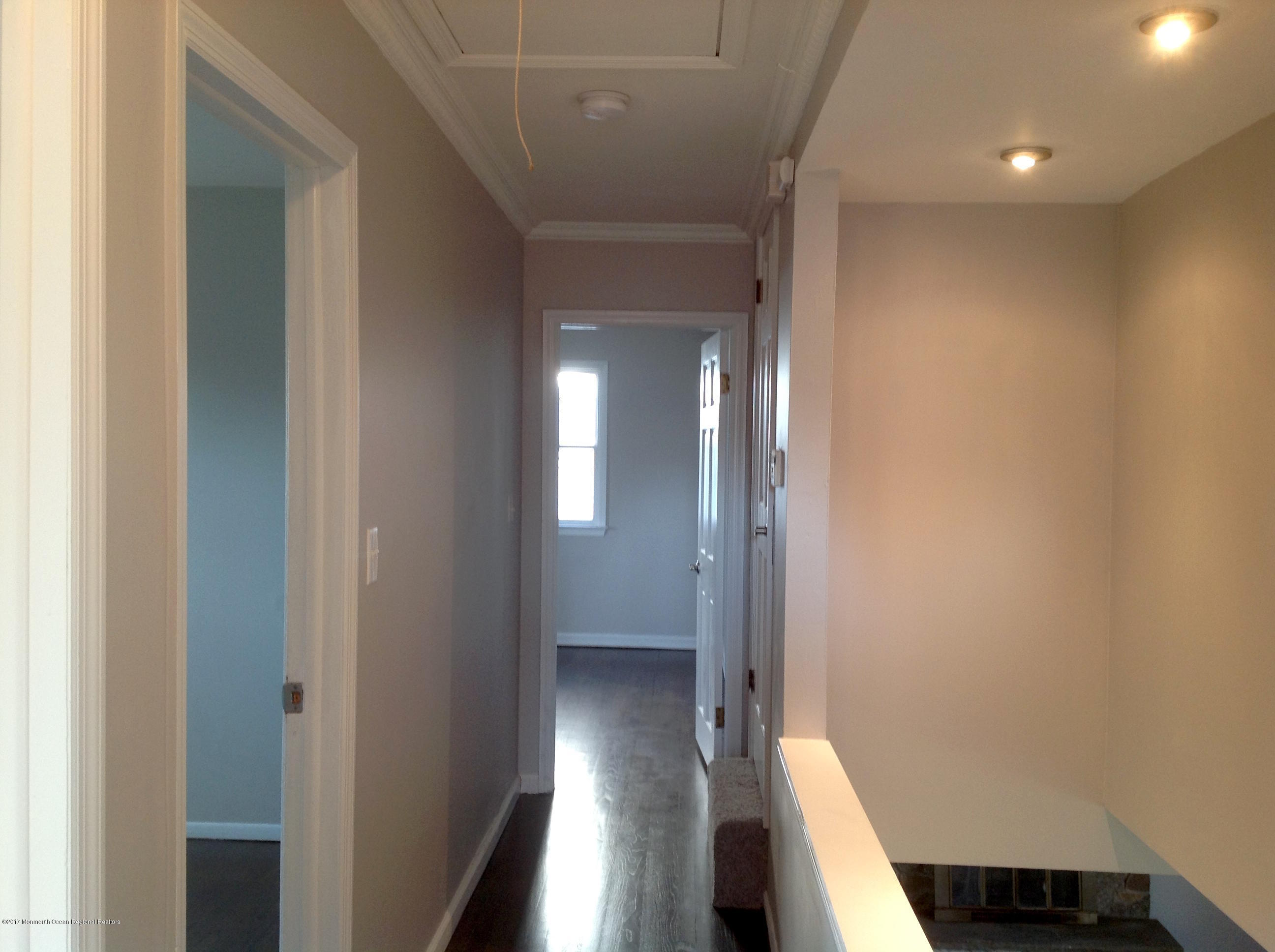 10 Carriage Road North Hazlet, NJ 07730 - Photo 9 of 24 a view of a hallway with wooden floor and staircase