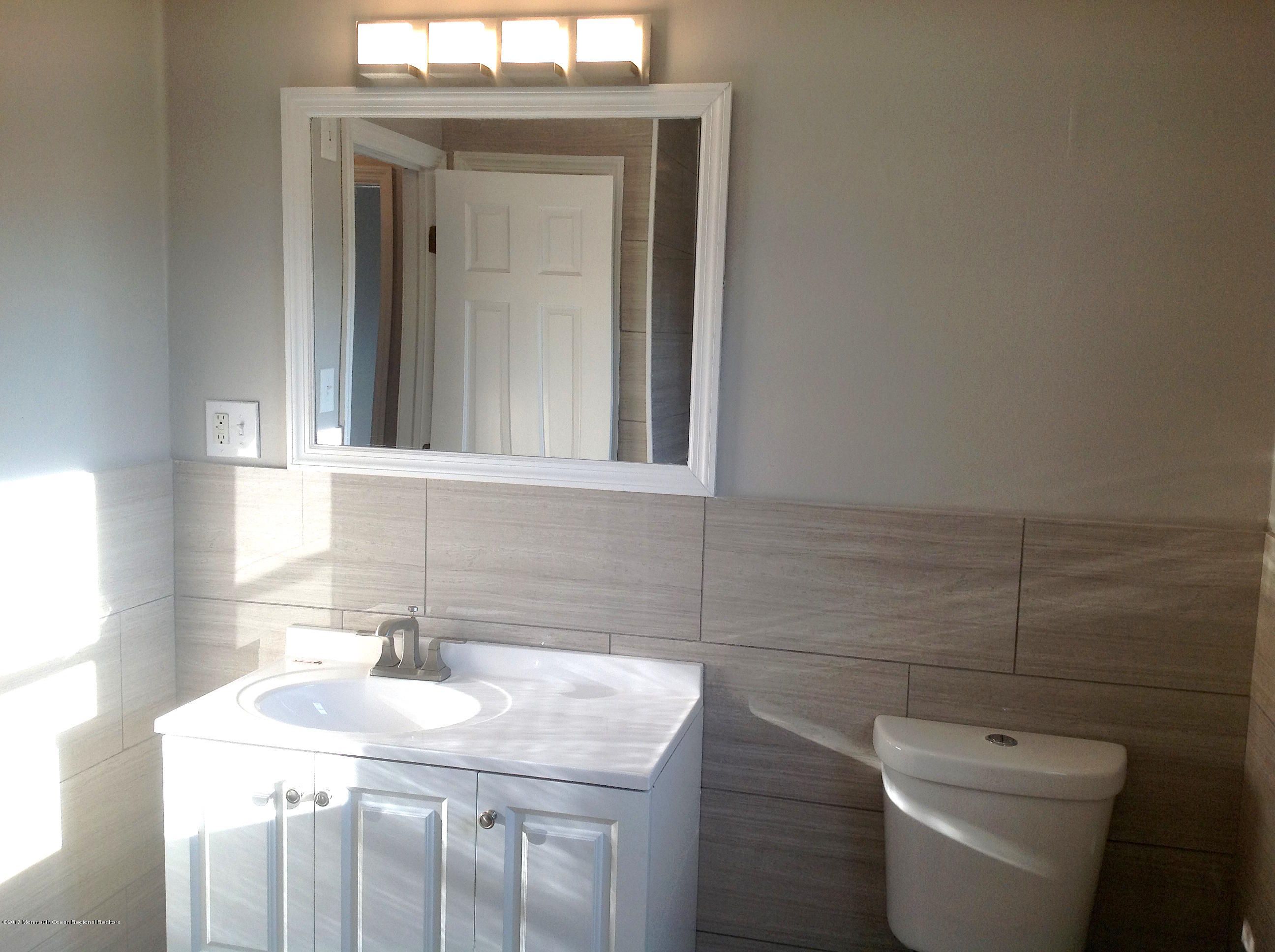 10 Carriage Road North Hazlet, NJ 07730 - Photo 10 of 24 a bathroom with a toilet sink and mirror