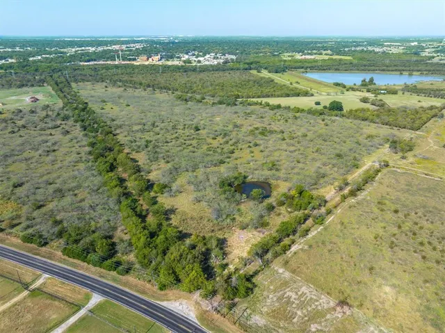 a view of a green field with an outdoor space