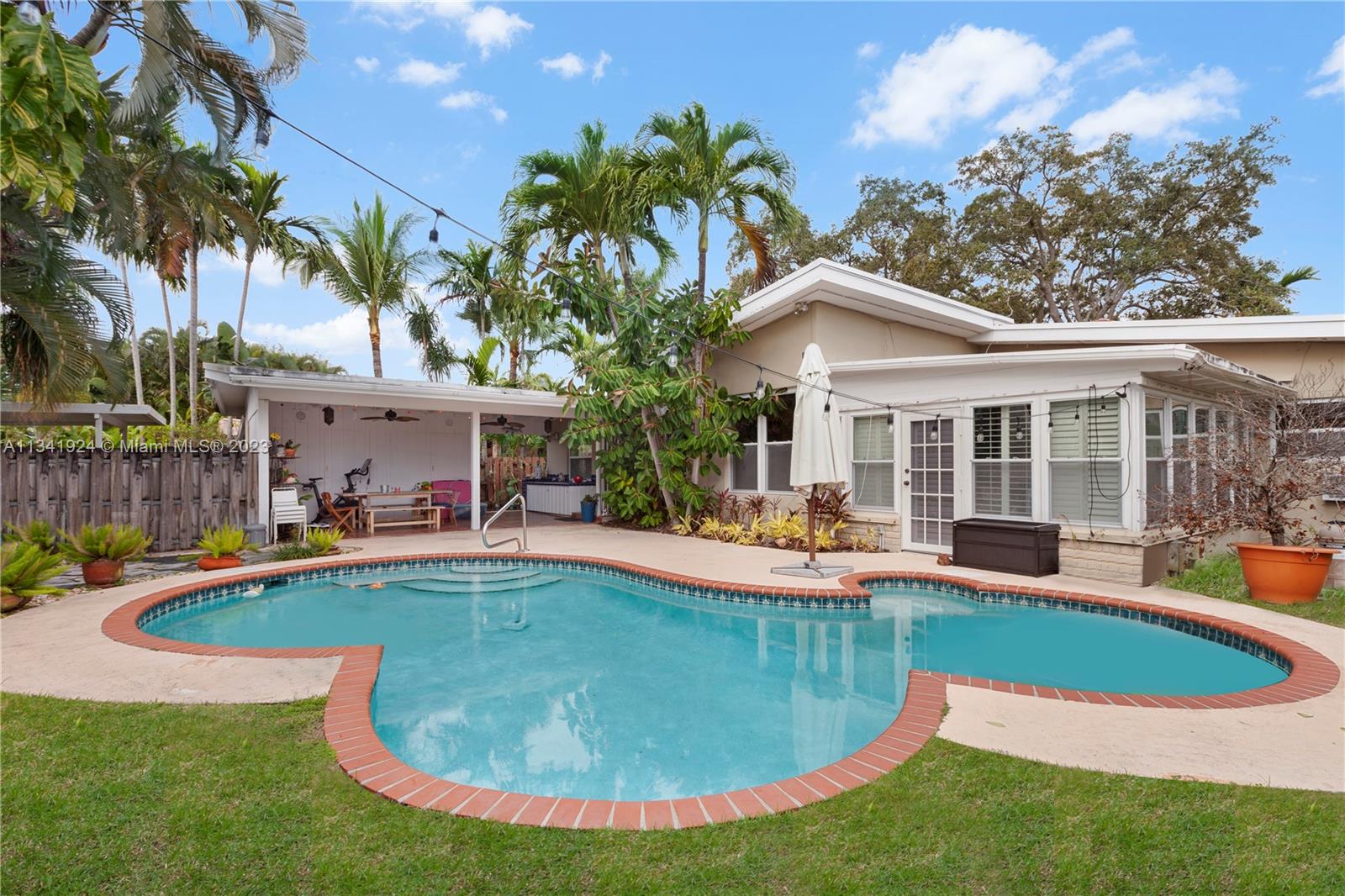 a view of a house with swimming pool and sitting area