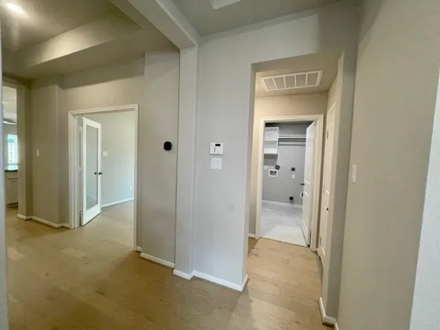 a view of a hallway with wooden shelves