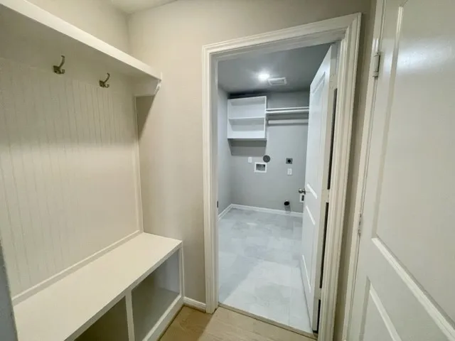 a large kitchen with cabinets a sink a window and stainless steel appliances