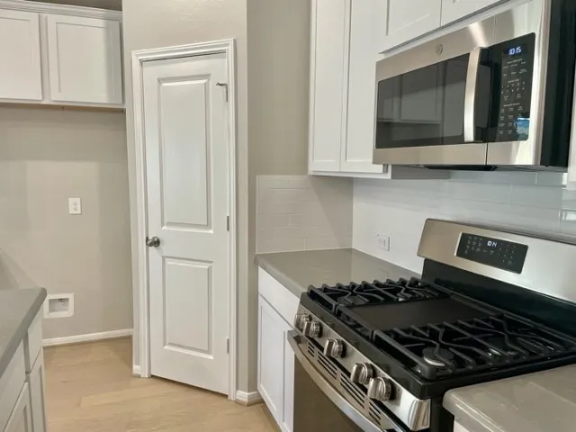 a kitchen with granite countertop a stove and a sink