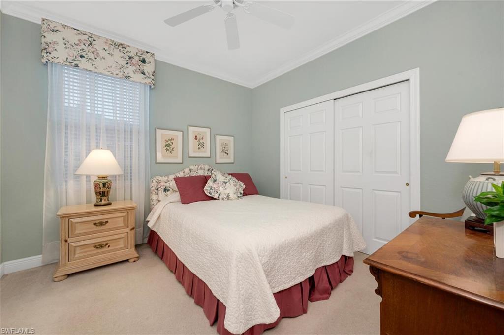 5044 Castlerock Way Naples, FL 34112 - Photo 13 of 38 a bedroom with a bed and a table in it