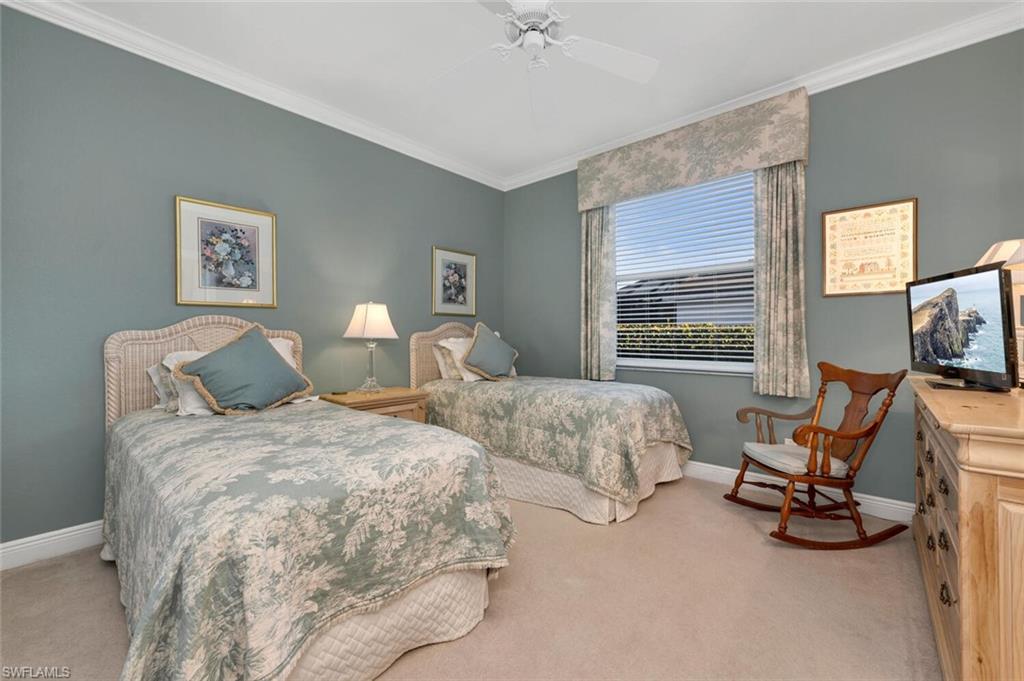 5044 Castlerock Way Naples, FL 34112 - Photo 15 of 38 a bedroom with two beds and a large mirror next to a window