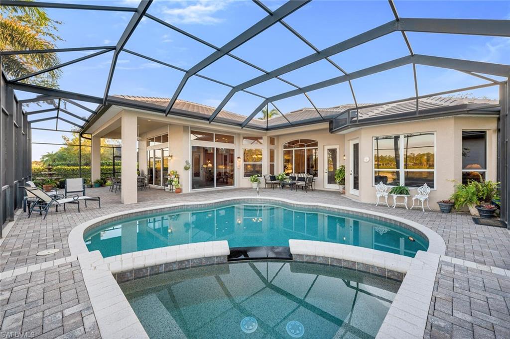 5044 Castlerock Way Naples, FL 34112 - Photo 21 of 38 a view of a patio with a table and chairs under an umbrella