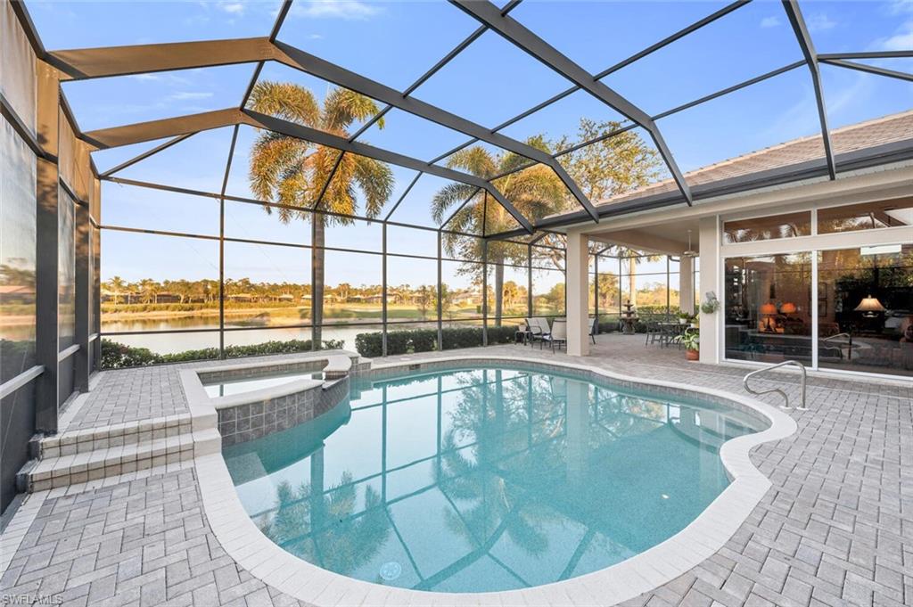 5044 Castlerock Way Naples, FL 34112 - Photo 22 of 38 a view of a swimming pool with outdoor seating