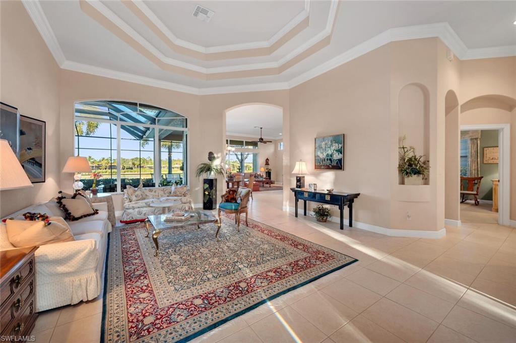 5044 Castlerock Way Naples, FL 34112 - Photo 4 of 38 a living room with furniture and a table